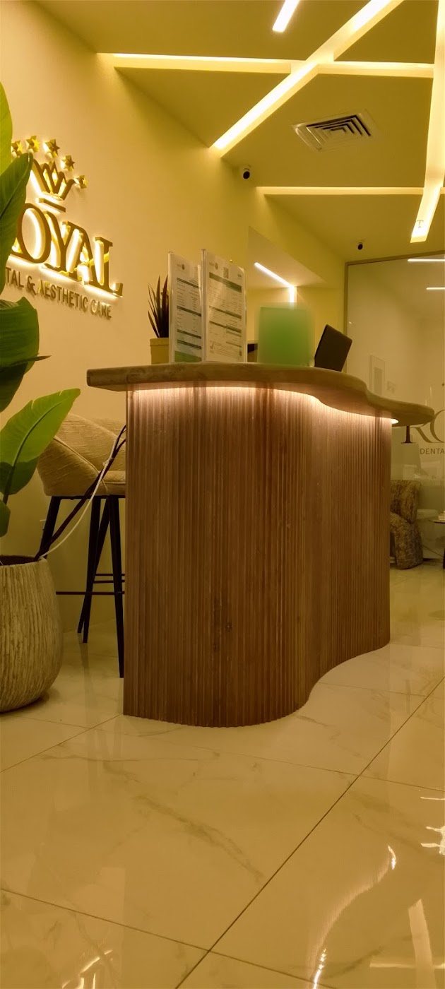 Reception desk at Royal Dental & Aesthetic Care with the gold Royal crown sign
